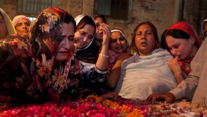 LAHORE-PAKISTAN-MAY 27: Pakistani women mourn over the body of Inspector Abdul Rauf Sultan killed in the suicide bomb attack killing at least 24 people and wounding around 300 on May 27, 2009 Lahore, Pakistan. The attack was a giant bomb in the center of the city aimed at the offices of the police and Pakistan's main spy agency. No group claimed respnsibility for the attack, the third in Lahore but most blame the Taliban for the violent retaliation since the army launched a sweeping operation against the Taliban in Swat region three weeks ago. 
(photo by Paula Bronstein /Getty Images)