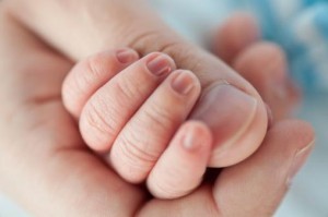 Father holding baby's hand