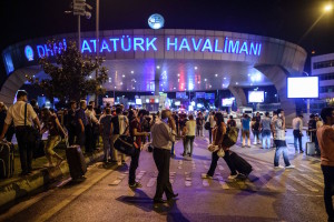 EDITORS NOTE: Graphic content / People stand outside the entrance as they leave the airport after two explosions followed by gunfire hit the Turkey's biggest airport of Ataturk in Istanbul, on June 28, 2016. 
At least 10 people were killed on June 28, 2016 evening in a suicide attack at the international terminal of Istanbul's Ataturk airport, Turkish Justice Minister Bekir Bozdag said. Turkey has been hit by a string of deadly attacks in the past year, blamed on both Kurdish rebels and the Islamic State jihadist group. / AFP / OZAN KOSE        (Photo credit should read OZAN KOSE/AFP/Getty Images)