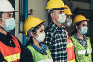 Factory workers with face mask protect from outbreak of Corona Virus Disease 2019 or COVID-19.